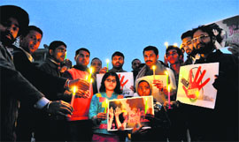 Members of social organisations take out a candlelight march at Sector 17 in Chandigarh on Saturday.
