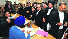 Officials during a Lok Adalat at the Judicial Complex in Sector 43, Chandigarh, on Saturday.