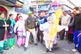 Congress workers burn effigies of Chief Minister Vijay Bahuguna and his son Saket Bahuguna in Mussoorie on Saturday in protest against the nomination of five persons as members to the Municipal Council