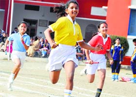 Girl students take part in a relay race during the annual sports meet at Cambrian Hall School in Dehradun on Saturday