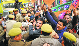 Activists of the BJYM protest outside the house of Justice Gandhi (retd) for giving a clean chit to former Minister of State Sajjad Kichloo in Jammu on Saturday.