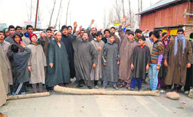 Villagers stage a protest against the Power Development Department in Kulgam district on Saturday.