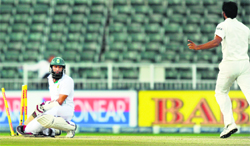 Hashim Amla looks stunned after being bowled out by Mohammed Shami on the fourth day of the first Test in Johannesburg on Saturday. AFP