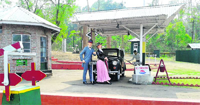 Model of a British couple and a petrol pump of British era at the museum