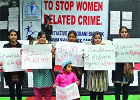 Activists hold a rally to protest violence against women at Jantar Mantar in New Delhi on Sunday