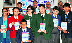 Young writers of various schools of Uttarakhand during the release of the compilation of their work in a book titled "Young Wings" in Dehradun on Sunday