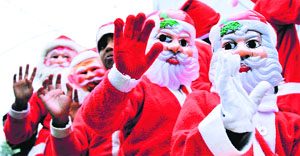 Children dressed as Santa Claus during a Christmas procession in Jammu on Sunday.