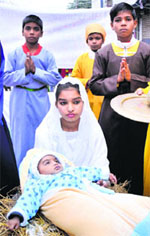 A child portrayed as baby Jesus during a Christmas procession in Jammu on Sunday