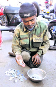Ahmed Ali from Bengal waits for alms in the Kachi Chawni area of Jammu.