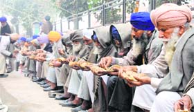 Farmers have a meal during a protest in Tarn Taran