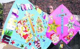Kite-maker Jagmohan Kanojia displays his specially made Christmas kite in Amritsar on Monday.