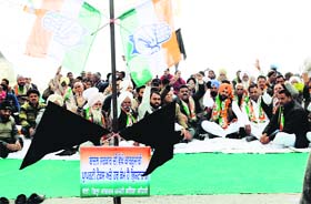 Congress ex-MLA from Bathinda Harminder Singh Jassi along with party workers raises slogan against the imposition of property tax during a chain hunger strike outside the Municipal Corporation office in Bathinda on Monday