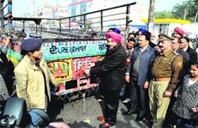 Safety first: Senior Superintendent of Police (SSP), Bathinda, Gurpreet Singh Bhullar, pastes a reflector on a tractor-trolley as a precaution in view of the foggy season in Bathinda on Monday