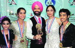 Winners of the 7th National Dancesport Championship with their trophy. a tribune photograph