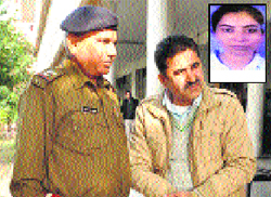 Accused Doon MLA Ram Kumar Chaudhary with a police official at District Courts in Panchkula on Monday Inset Jyoti). Tribune photo Nitin Mittal