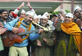 ON SONG: Supporters of the Aam Aadmi Party jubilate in New Delhi on Monday after the party chief Arvind Kejriwal met Lt. Governor Najeeb Jung to stake claim to forming government in Delhi