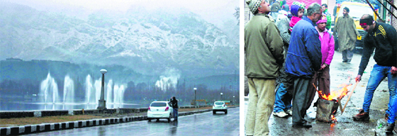 A view of the snow-covered Zabarwan mountains in Srinagar; and (right) city residents gather around a bonfire on Monday. Tribune photo: Yawar Kabli 