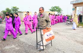 A patient returns disappointed as PIMS employees, who have not been paid wages, hold a protest march in Jalandhar on Monday