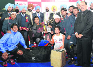 The winning Air India team strike a pose after lifting the All-India Sahibzada Ajit Singh Hockey Tournament at the Punjab Agricultural University on Monday.