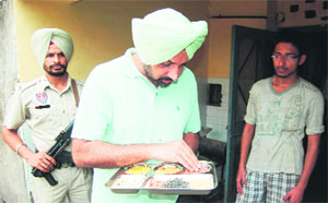 District health officer Dr Shiv Karan Singh Kahlon collects samples during a raid at GNDU boys hostel mess in Amritsar