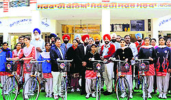 Chairman of Bathinda Zila Parishad Gurpreet Singh Maluka (in black coat) after distributing bicycles among the girl students in Bathinda on Tuesday