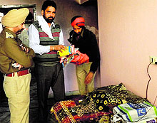 Police officials at the house where the retired teacher was burnt to death in Bathinda on Tuesday
