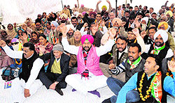 District Congress workers raise slogans during the ongoing dharna outside of the BMC office in Bathinda on Tuesday