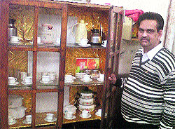 Rajesh, a railway canteen contractor, with the British era crockery in Bathinda on Tuesday