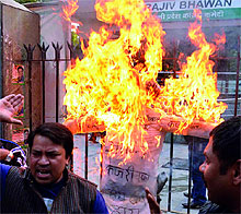 Congress workers burning an effigy of Arvind Kejriwal during a protest against the party's support to the Aam Aadmi Party, at DPCC in New Delhi on Tuesday