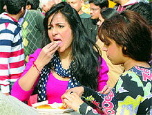 Foodies savour delicacies during the ongoing Dilli Ke Pakwaan festival in New Delhi on Tuesday