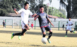 Players vie for the ball during the Swami Vivekananda Memorial Football Tournament at Pavillion Ground in Dehradun on Tuesday