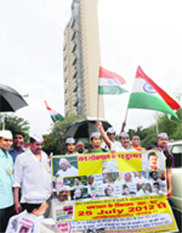 A protest against the Adarsh housing scam. The inquiry commission described the fraud as a sordid tale of political patronage, misuse of power and subversions of law. A file photo by PTI