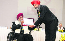 Dr Harvinder Singh Dhaliwal, an alumnus, receives the award of honour during the alumni meet of Punjab Agricultural University on Tuesday.