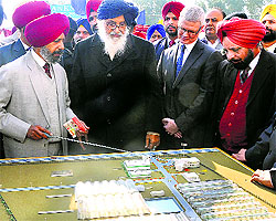 Chief Minister Parkash Singh Badal looks at the model of the Centre of Excellence for green revolution after its inauguration in Jalandhar on Tuesday