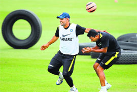 Captain MS Dhoni (L) and Pragyan Ohja during a training session ahead of the second Test at the Sahara Stadium Kingsmead in Durban.