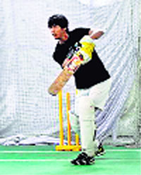 Somdev Devvarman tries his hand at cricket in Agartala on Tuesday.
