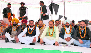 Congress workers sit on dharna in Bathinda on Wednesday.