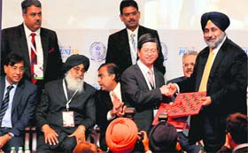John H Lin, vice-chairman, CTCI Corporation, Taiwan, exchanges documents with Sukhbir Singh Badal, Deputy CM, Punjab, during the Investors Summit in Mohali