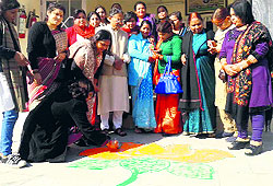 BJP women workers make a rangoli at the residence of former CM BC Khanduri to celebrate the birthday of former PM Atal Bihari Vajpayee in Dehradun on Wednesday