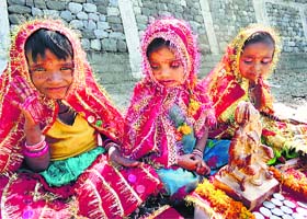 Girls ask for alms from commuters on the Banganga Road in Katra