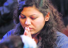 A devotee attends Christmas prayers at Holy Family Catholic Church in Srinagar on Wednesday