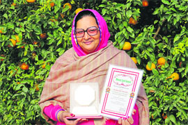 Karamjit Kaur Danewalia displays the awards at her orchard in Abohar.