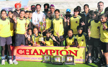 Sonepat players pose with the trophy after winning the Shaheed Udham Singh Junior Girls Hockey Meet in Amritsar on Thursday.