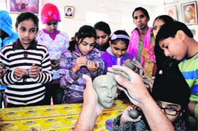 Art lessons: Students being taught clay modelling at the ongoing art workshop being held by Sobha Singh Memorial Chittarkar Society at Teachers Home in Bathinda on Thursday