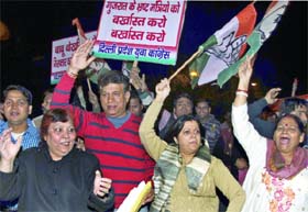 Congress workers shout slogans during a demonstration against the alleged corruption in the Gujarat Government, near BJP president Rajnath Singh's residence in New Delhi on Thursday