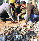 Policemen investigating the site at Dilli in Jammu where the explosion took place. A Tribune Photograph: Inderjeet Singh