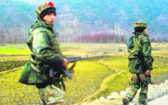 Army men patrol the Tral area of Pulwama district after a gunfight with militants. Tribune photo: Yawar Kabli