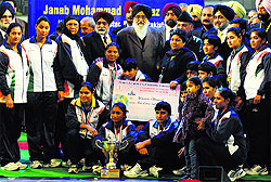 Members of the Indian womens kabaddi team, winners of the event, pose for a photograph with CM Parkash Singh Badal and Deputy CM Sukhbir Singh Badal