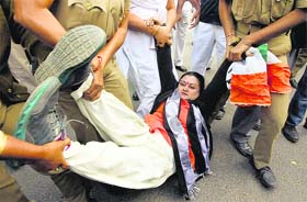Police arrest a Youth Congress activist during a demonstration against the state government in Kolkata on Thursday
