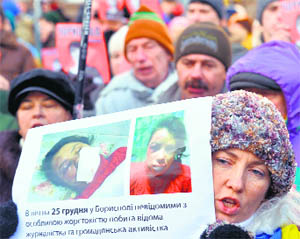 Protesters hold photos of Tetyana Chornovil, popular Ukrainian journalist and opposition activist, during a rally in Kiev on Thursday.
